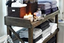 08 add a wooden stand with towels, candles, soaps and flowers for a stylish feel