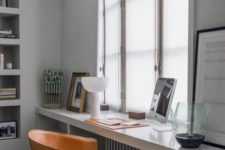 09 a modern windowsill desk with open storage shelves on both sides and a comfy leather chair