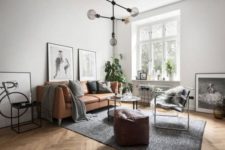 09 an airy and light-filled Nordic space with a tan leather sofa and ottoman looks wow