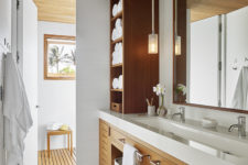 10 The bathroom is done with natural wood and white surfaces, there’s a window even here