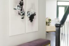 10 a modern glam entryway is nailed with a mauve upholstered bench and cool abstract artworks