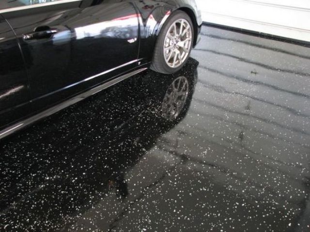 black epoxy floors installed in a garage because they are resistant to everything and aren't expensive