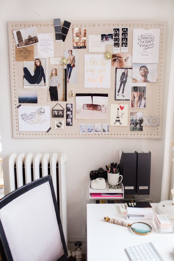 a fabric covered pinboard decorated with nails that line it up