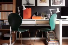 14 a moody workspace with a black wall, emerald chairs and a couple of Micke desks