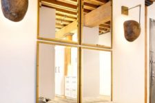 16 a bold glam space with a framed mirror collage and a comfy white leather bench on gilded framing