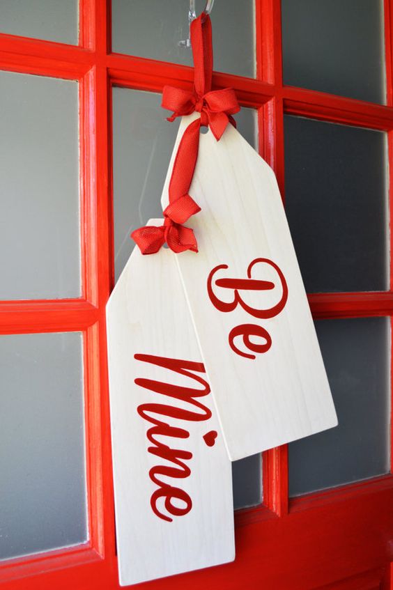 large handmade door tags instead of a traditional wreath is a bold idea