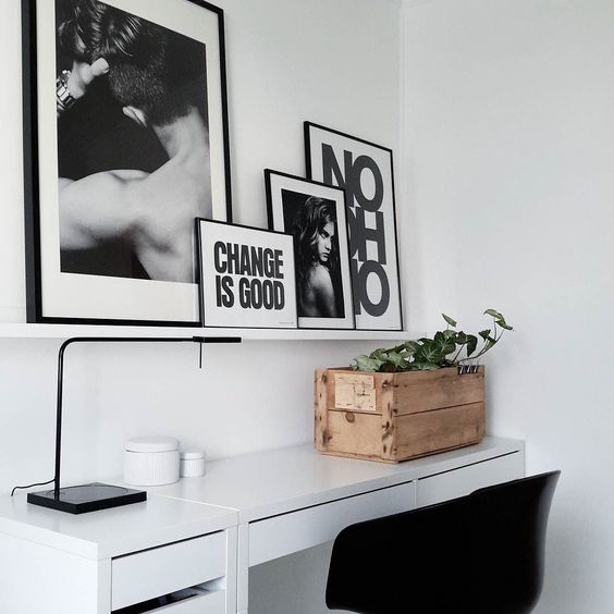 a stylish workspace with a Micke desk, a drawer unit and a ledge with various artworks