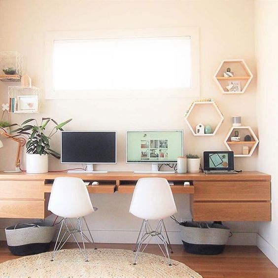 a custom-made floating desk for two and some floating shelves on each side