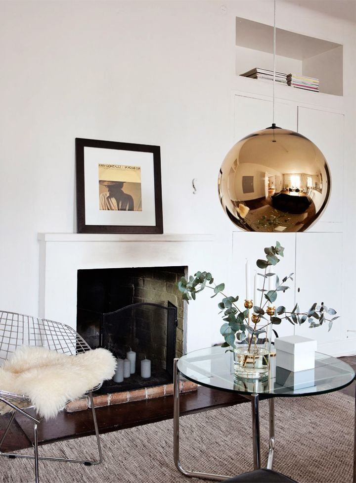 stainless steel metal frames of the chairs and a large brass bubble lamp