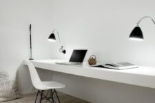 23 a minimalist workspace with a floating desk, lamps and a modern chair