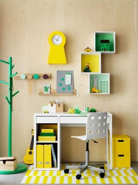 a colorful yellow and green kid's study space with a Micke desk and some box shelves