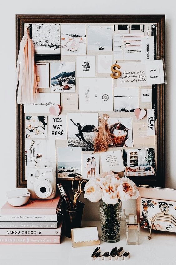 a fabric pinboard in a dark stained wooden frame looks chic and stylish