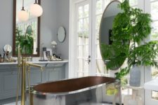 24 a large metal tub is the main eye-catcher in this bathroom, and brass touches make it cozier