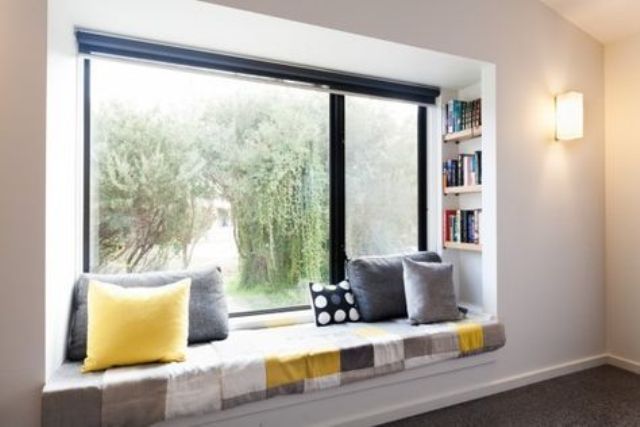 a comfy reading space with built-in bookshelves on both sides of the seat