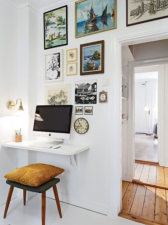 a tiny floating desk completed with a comfy upholstered stool  for a small workspace