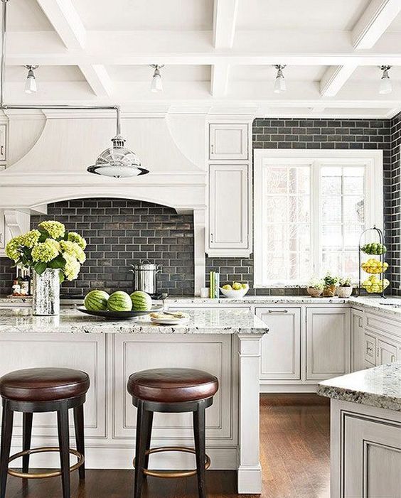 a black subway tile backsplash with white grout makes the neutral kitchen more interesting
