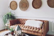02 a boho space with an amber leather Chesterfield and baskets on the walls