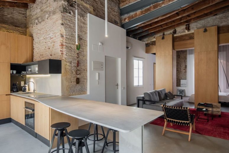 open plan kitchen design The kitchen and living room are united into an open layout with light-colored wood and industrial touches