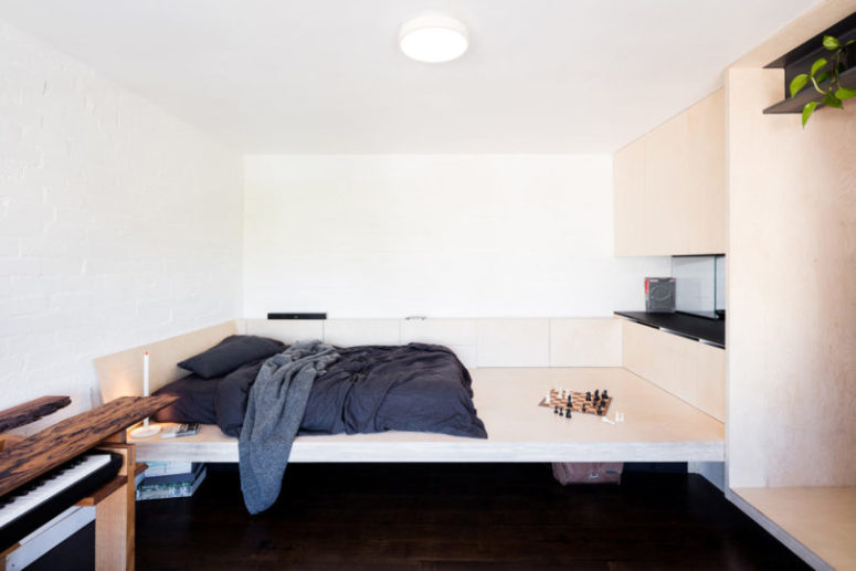 White walls make the space larger, and light colored plywood continues with this idea while adding texture White walls make the space larger, and light-colored plywood continues with this idea while adding texture
