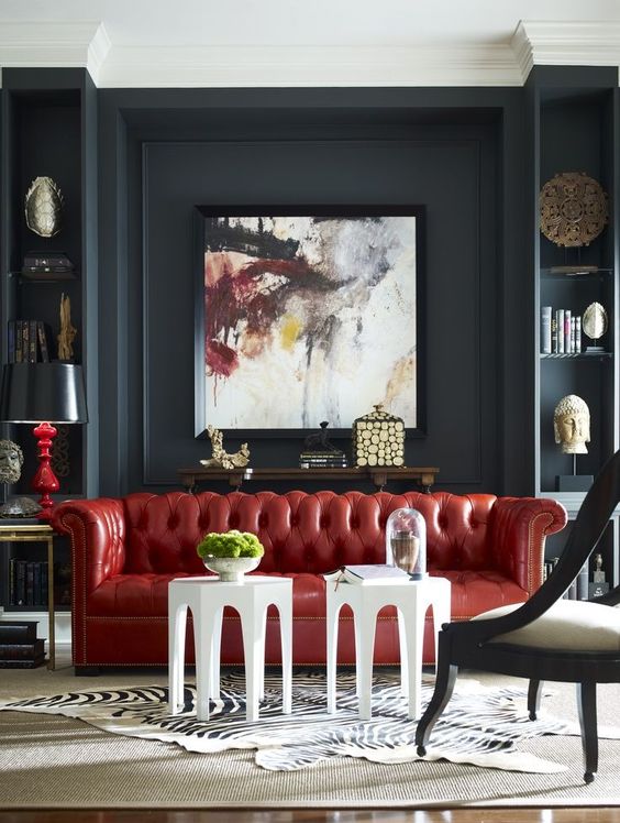 a bold red leather Chesterfield makes a colorful statement in this moody space