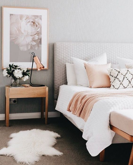 an oversized flower artwork on one side of the bed for a spring feel