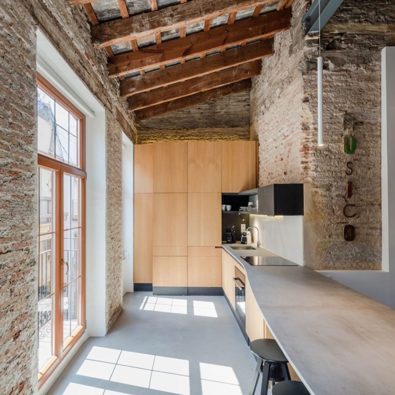The kitchen has much natural light, and though it's small, it's functional featuring a kitchen island that doubles as a dining space The kitchen has much natural light, and though it's small, it's functional featuring a kitchen island that doubles as a dining space