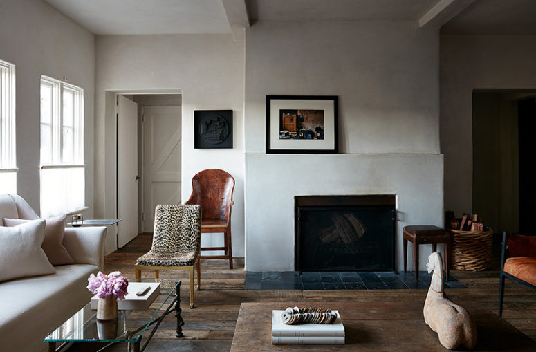 The walls are done with white plaster, the floor is of weathered wood, a fireplace adds coziness and baskets too The walls are done with white plaster, the floor is of weathered wood, a fireplace adds coziness and baskets too