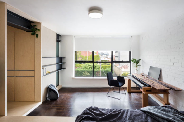 You may see some shelves on the wall, there's a working space covered with wood that hides a musical instrument You may see some shelves on the wall, there's a working space covered with wood that hides a musical instrument