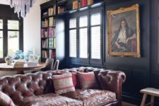 04 a large moody open layout with a brown leather Chesterfield as the main statement piece