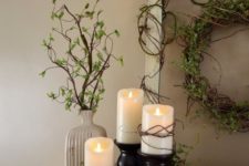 04 a vine wreath with greenery, pillar candles and cascading greenery plus some in a vase
