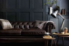 05 a moody living room with a dark brown leather sofa and a matching animal skin rug