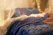 05 airy fabric canopy over the bed with string lights attached for a boho bedroom
