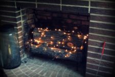 06 put firewood and then add a string or two of twinkle lights in the fireplace to add a soft glow to the room