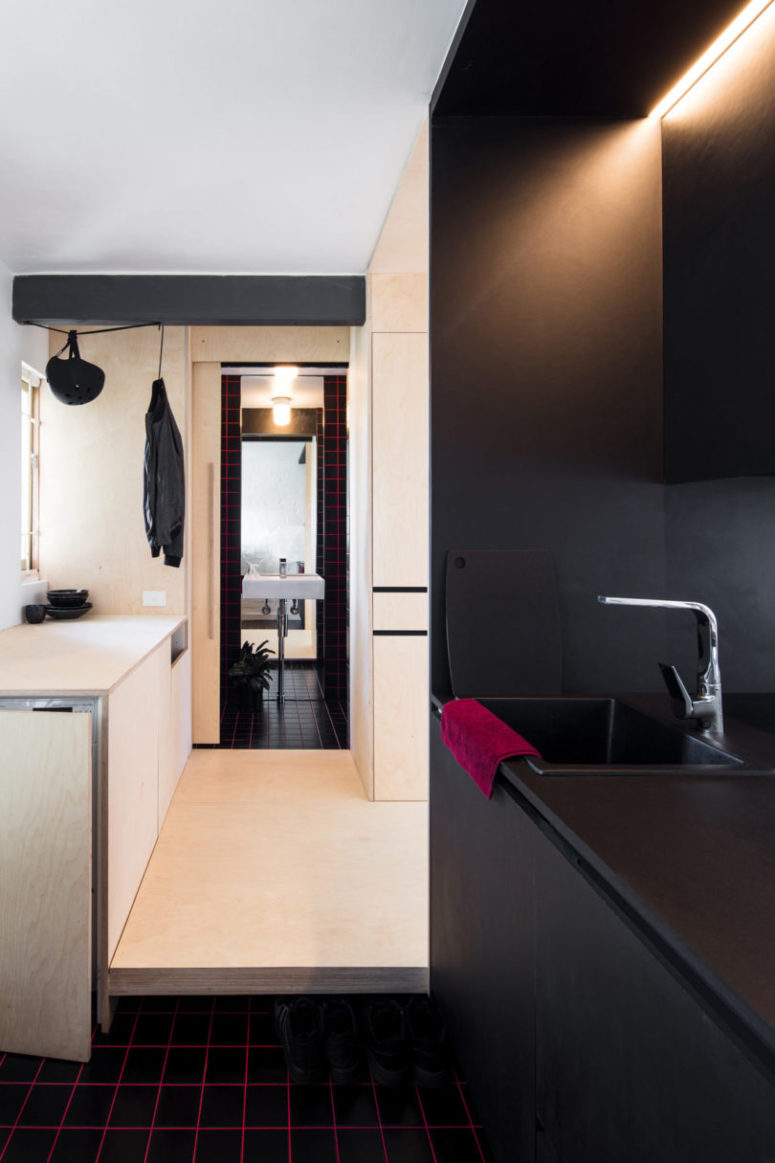 Black surfaces combined with light colored plywood are a great idea for creating a stylish and contrasting space Black surfaces combined with light-colored plywood are a great idea for creating a stylish and contrasting space