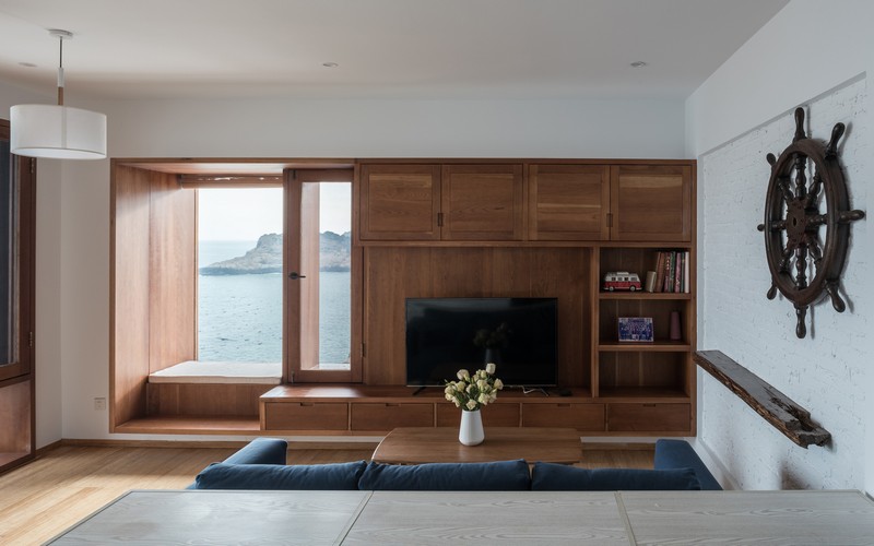 Large windows with comfy windowsills allow enjoying the views of the sea
