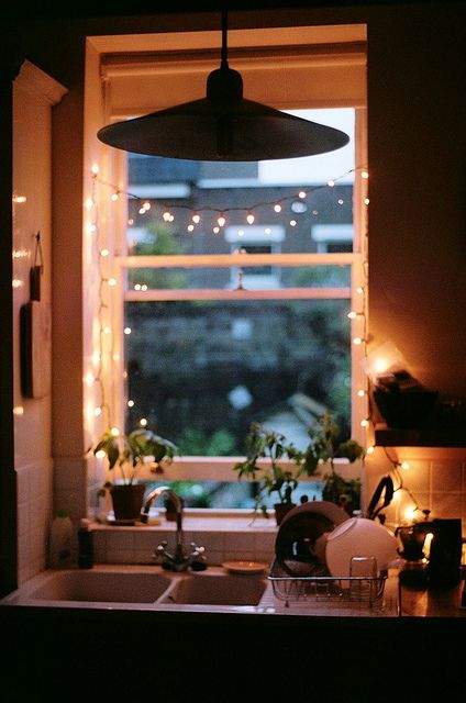 hanging string lights in the window will make the space cozier from inside and outside, too
