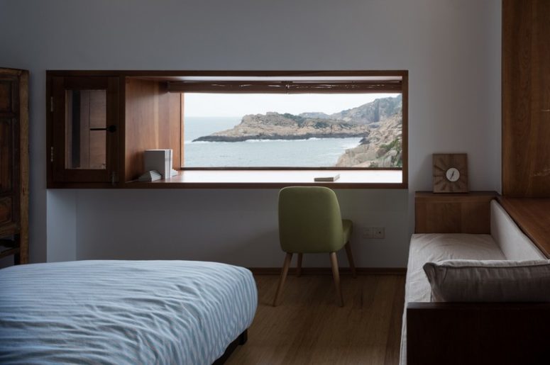 One of the bedrooms with a large windowsill desk, a comfy sofa and amazing views