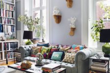09 a cozy pastel living room with a light grey Chesterfield sofa and lots of books