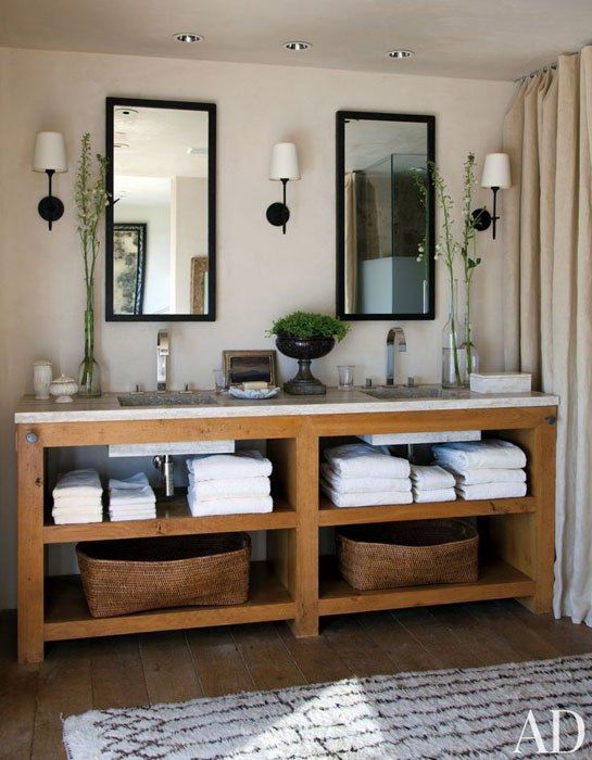 a double vanity with open shelves and a marble countertop