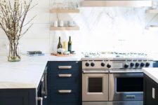 11 a navy kitchen with white marble countertops and a backsplash for a more elegant look