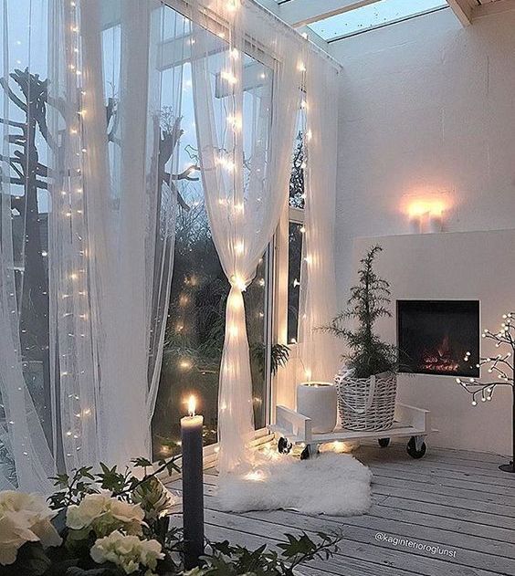 a glazed wall and sheer curtains with light integrated for a stylish and cozy look