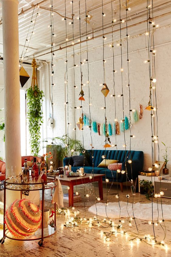 separate an open space with string lights hanging - it's a cute and glam idea for any space
