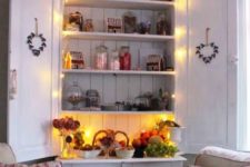 15 a vintage kitchen cabinet highlighted with string lights can be a display or some bar