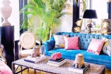 16 a bold art decor space with bright blue Chesterfield sofas and a woven coffee table