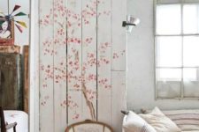 16 a whitewahsed pallet screen with tender cherry blooms to accent the bedroom