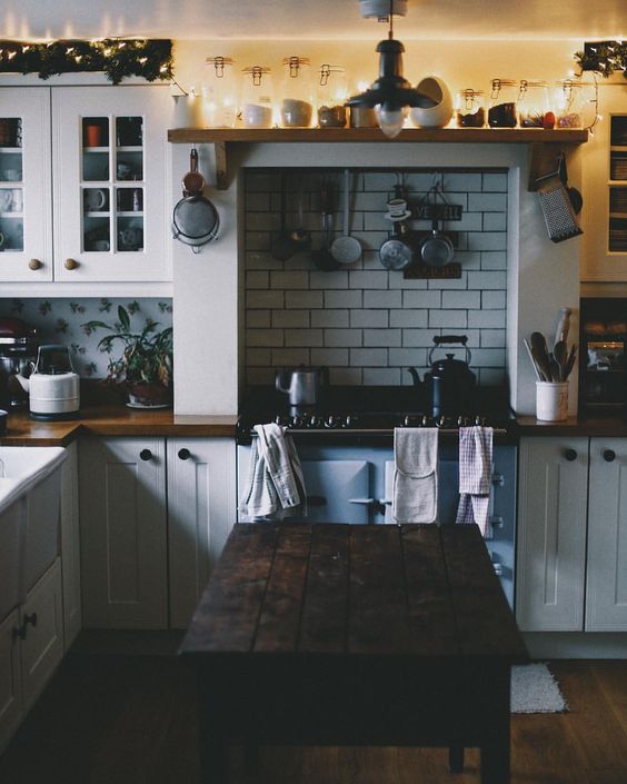 string lights above the cabinets make this traditional kitchen more cheerful and fresh