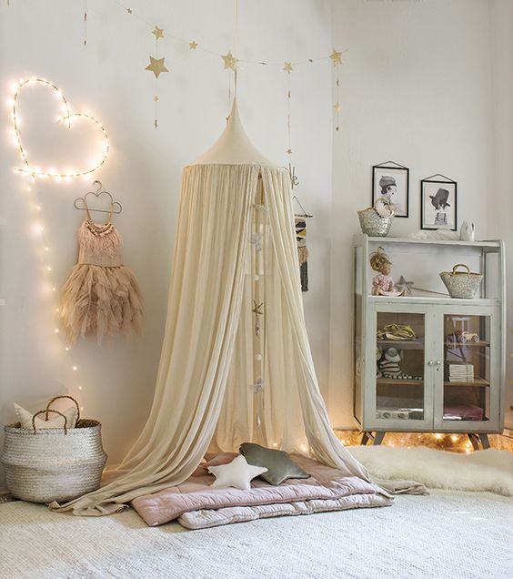 a cute heart string light sign and some lights under the furniture make the space cozy and cute