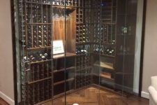 19 a glazed wall wine cellar allows keeping a necessary temperature here and glass walls highlight it