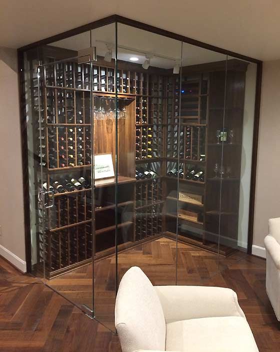 a glazed wall wine cellar allows keeping a necessary temperature here and glass walls highlight it