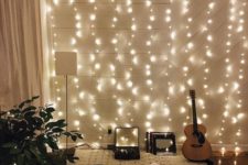 20 a hobby nook in the living room is accented with a whole string lights wall
